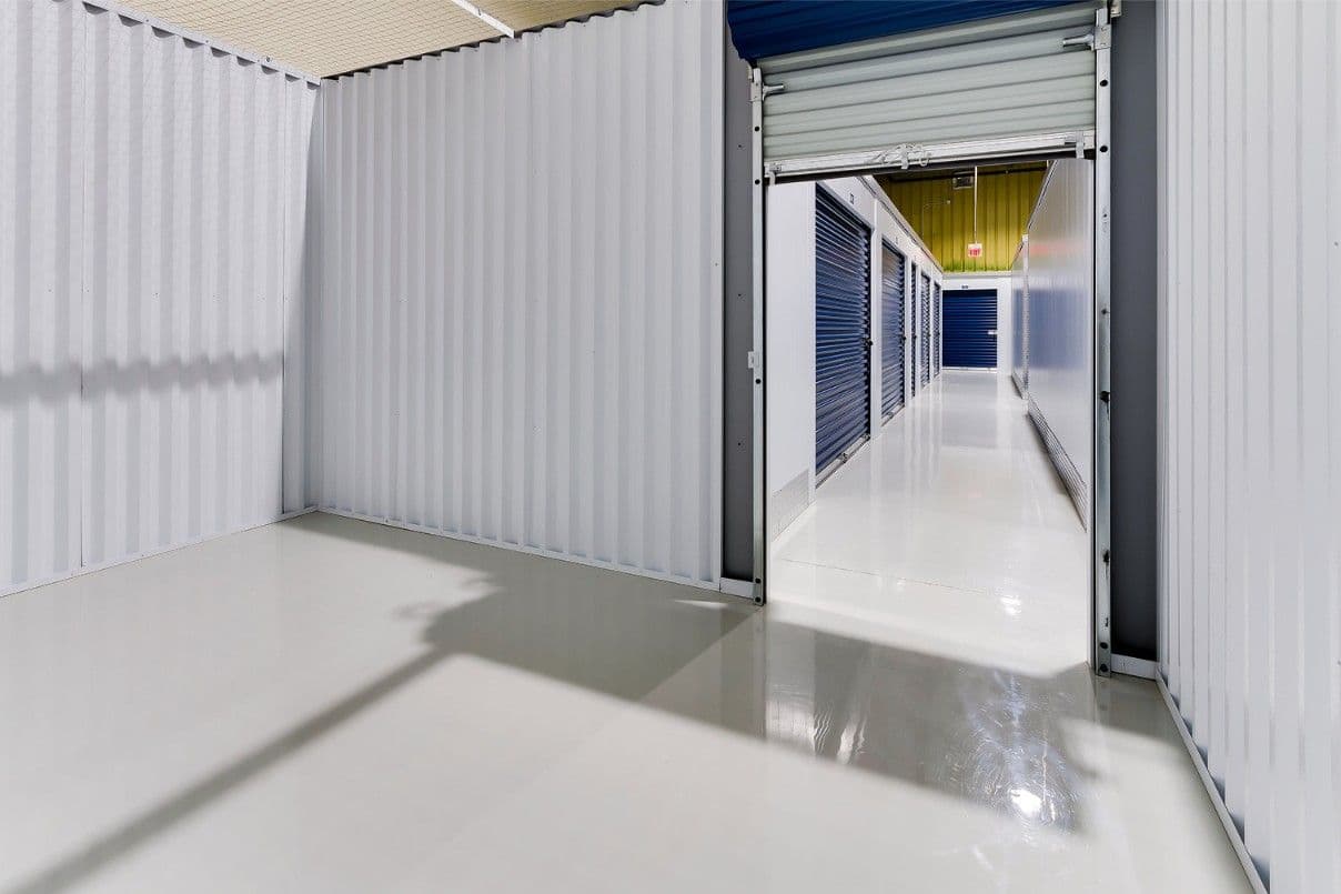Open storage unit with a blue roll-up door at CityBox Manchester