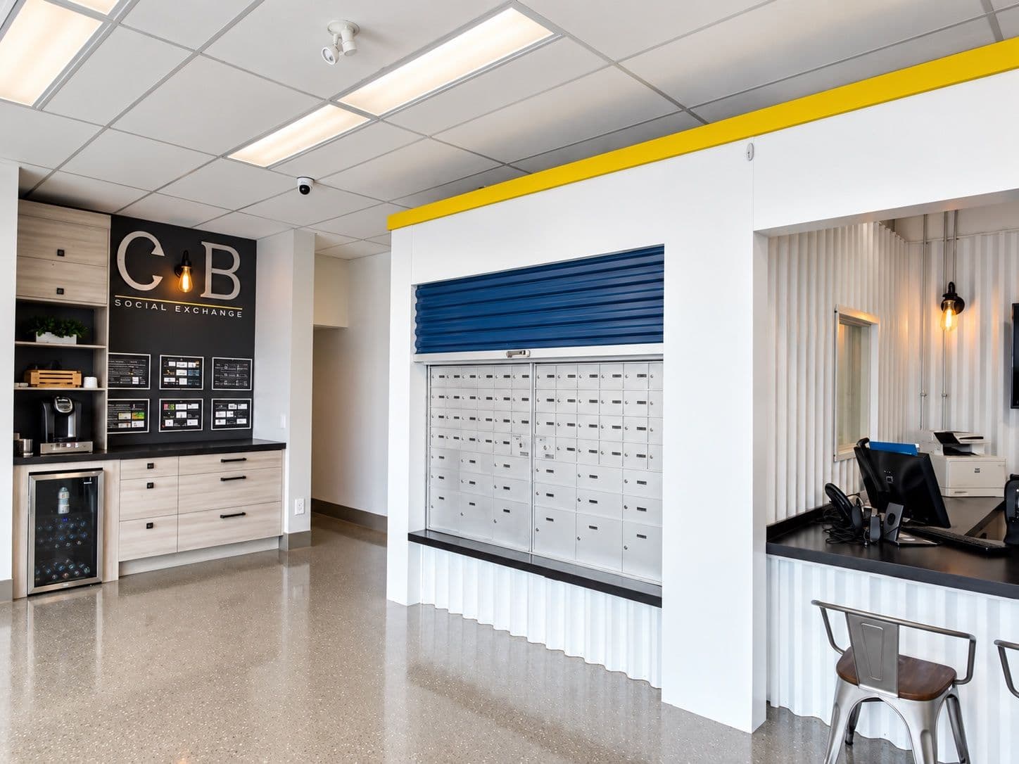 CityBox Manchester office: coffee station, private mailboxes behind a blue roll-up door, and the front desk